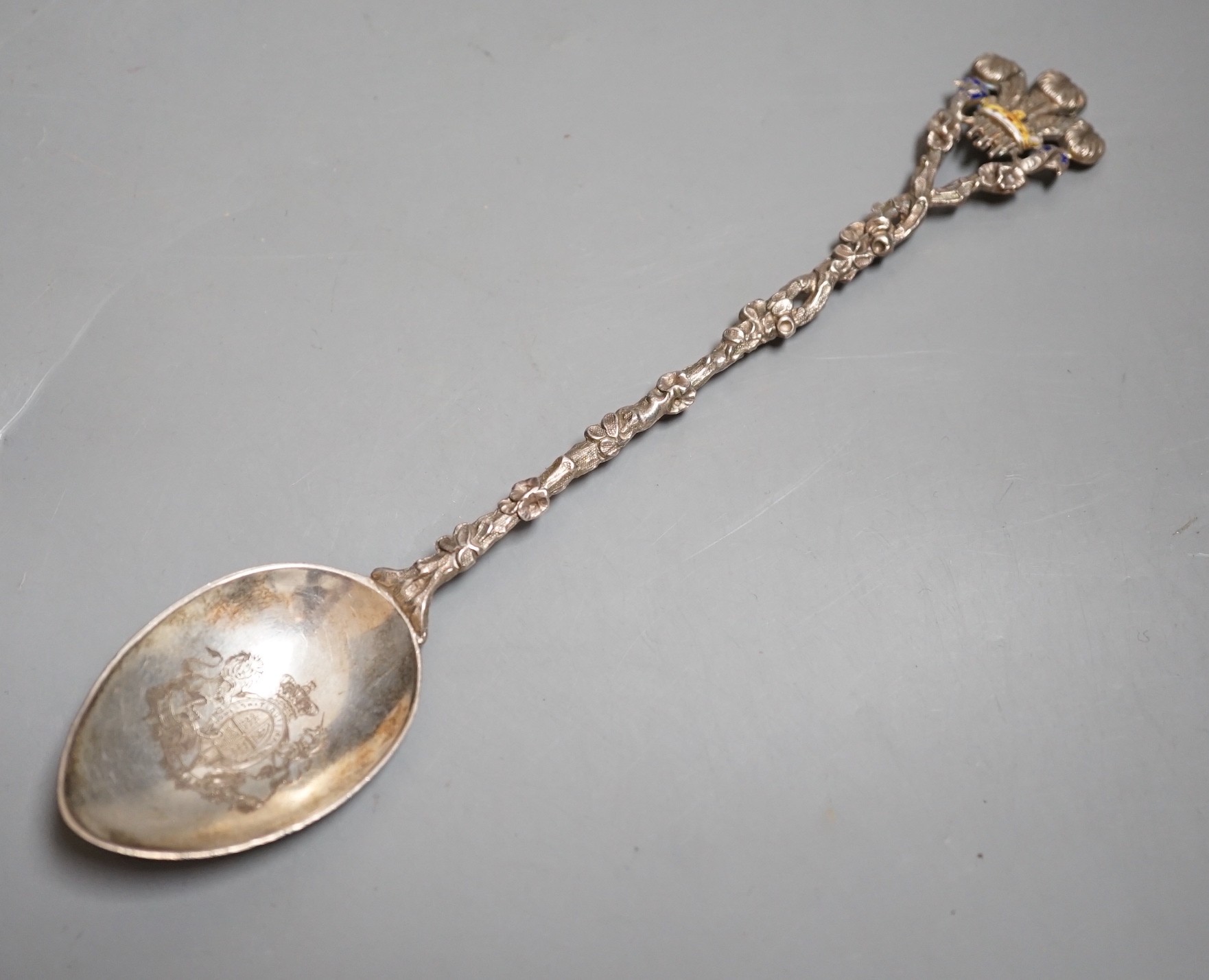 A late Victorian silver and enamelled spoon, with rustic stem and Prince of Wales feathers terminal, the bowl engraved with the Royal Coat of Arms, Saunders & Shepherd, London, 1896, 20.2cm, gross 43 grams.